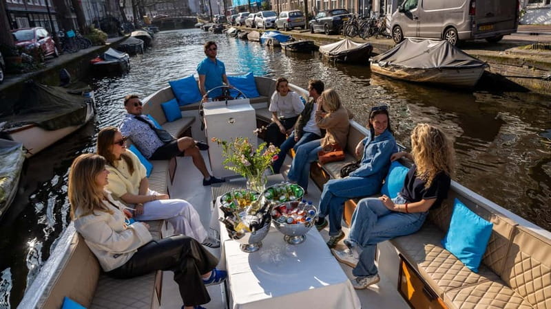 Amsterdam: Canal Cruise in Open Boat with Drink Option - Live commentary from guides such as Sebastian and Jaro