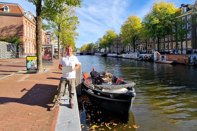 Amsterdam Canal Tour by Open Boat – 90 min Small Group Experience - Medieval locks, warehouses, and De Waag