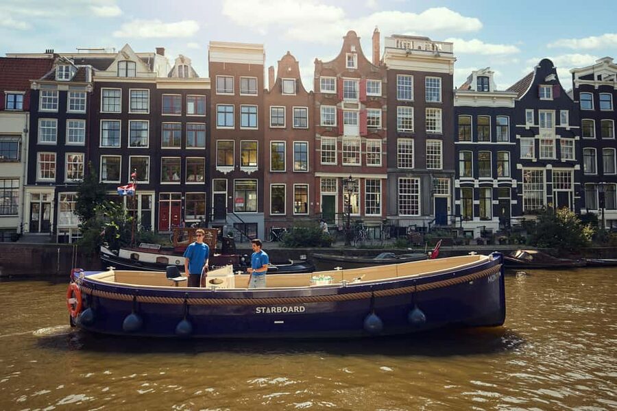 Amsterdam: Cozy Evening Canal Cruise With Open Bar Option - Rain, seating, and the small-boat feel