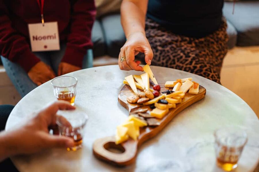Amsterdam: Guided Cultural Food Tour in German or English - Damrak Avenue and Beurs van Berlage show old and new Amsterdam