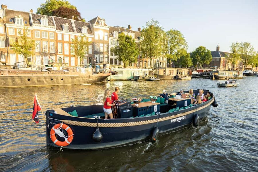 Amsterdam: Guided Open Boat Canal Cruise Including Drink - The opening view: Centraal Station, the Sea Palace, and Saint Nicholas