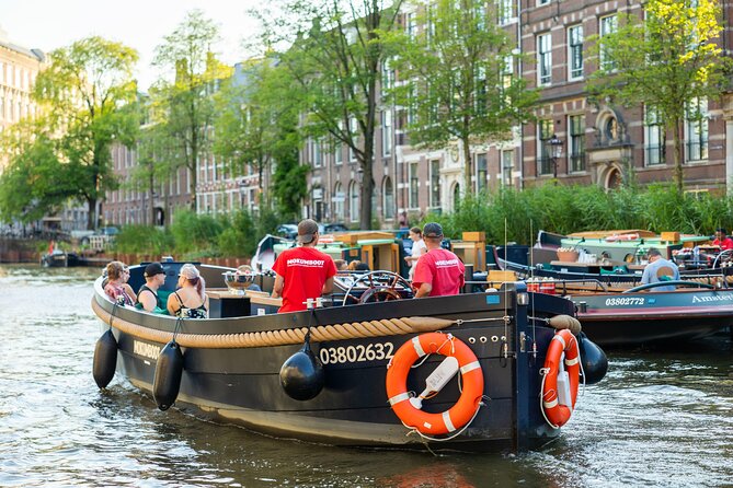 Amsterdam: Guided Open Boat Canal Cruise Unlimited Drinks Option - Markets, bridges, and the Amstel