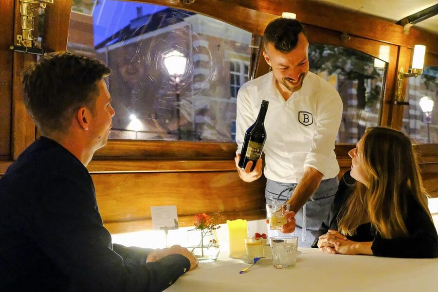 Amsterdam: Luxury Saloon Boat Cruise with 3-Course Dinner - A dining room that moves through Amsterdam