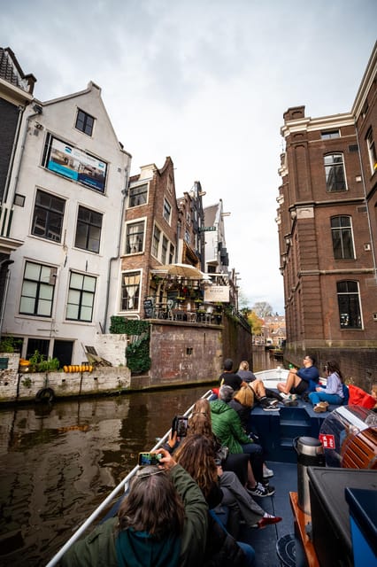 Amsterdam:Old City Canal Cruise with Live Guide and Open Bar - Open boat comfort, seating, and weather