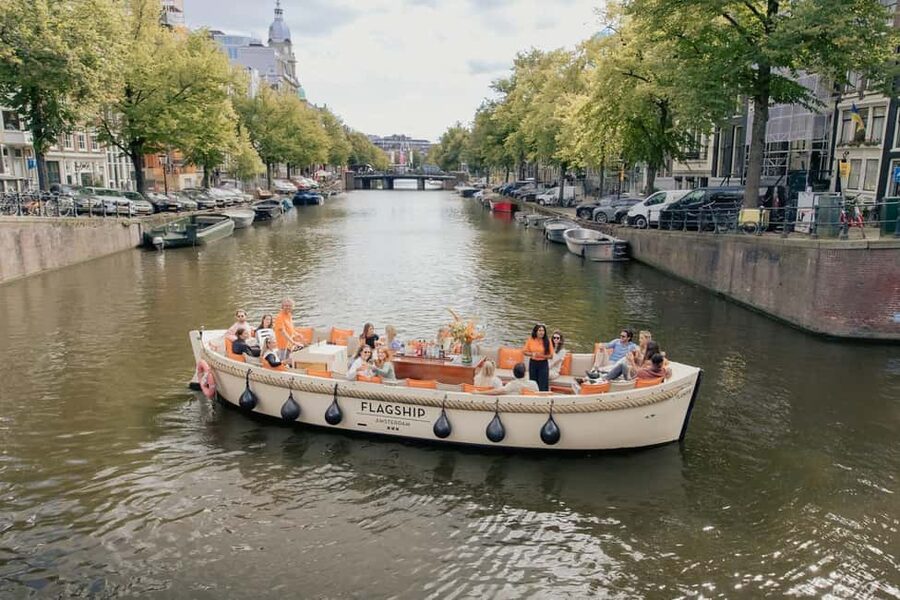 Amsterdam: Open Boat Cruise option Unlimited Drinks & Bite - The Skinny Bridge and the Amstel
