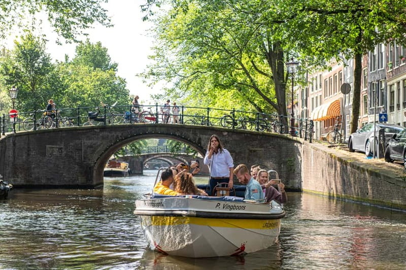 Amsterdam: Open Boat Tour of Canals with Expert Local Guide - Starting near Damrak, the city’s postcard front door
