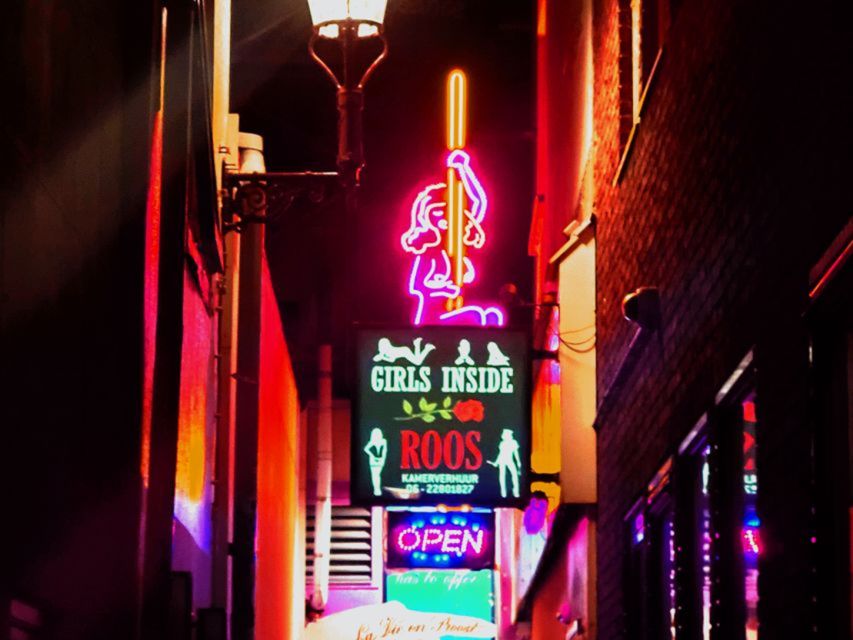 Amsterdam: Red Light District and Coffeeshop Culture Tour - Entering the Red Light District through its famous sights