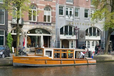 Amsterdam small-group canal cruise in 1920s saloon boat