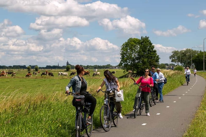 Amsterdam: Windmill, Cheese, and Countryside E-Bike Tour - Leaving Amsterdam by ferry and bicycle