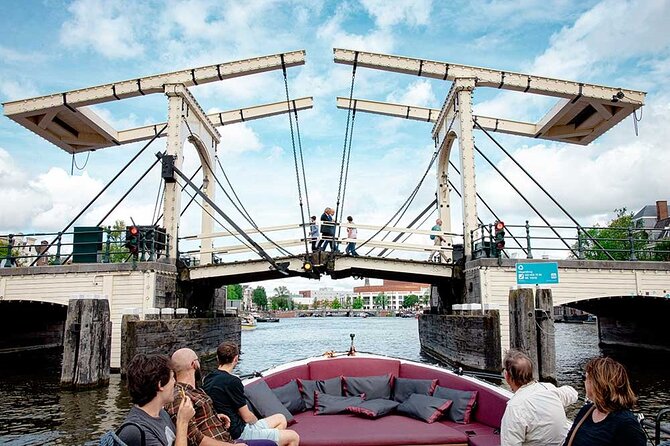 Guided Amsterdam Canal Cruise – Snacks & Drinks on board(1 Hour) - Medieval walls and quieter waterways