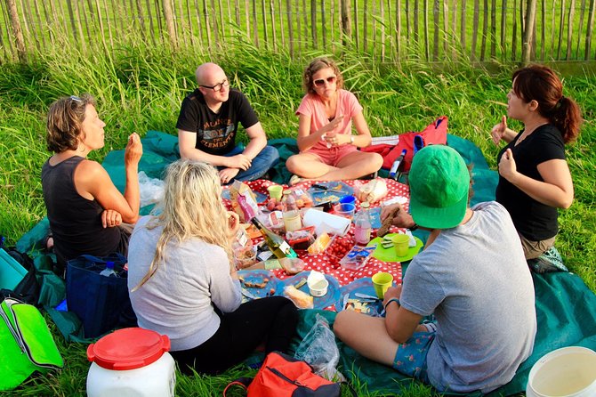 Small-Group Guided Sunset Canoe Tour in Waterland with Dinner - Paddling through reeds, meadows, and wooden homes